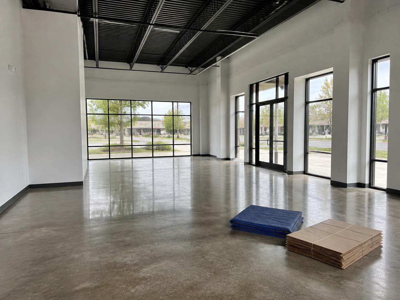 Empty commercial space with polished floors and spotless glass after a final post-construction clean