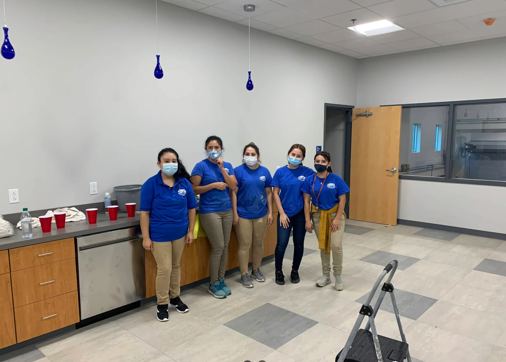 Better Cleaning Solutions crew in branded shirts at a commercial break room